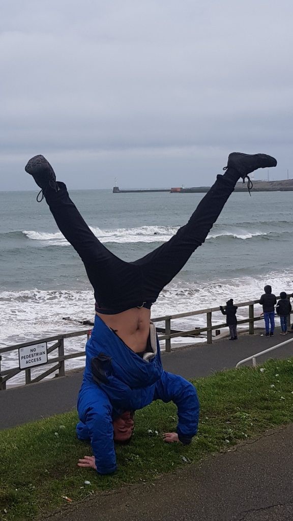 Finbarr doing a headstand on the Aberdeen seafront